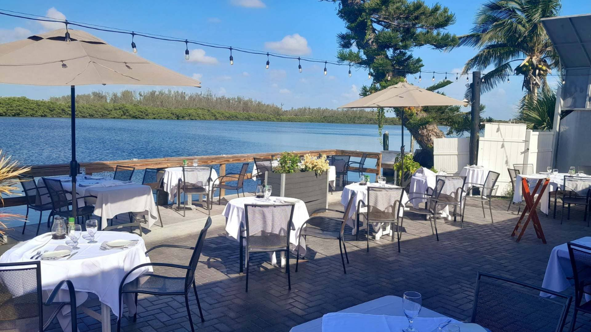 Dining al fresco at Ophelias on the Bay with view of Sarasota Bay in the background.